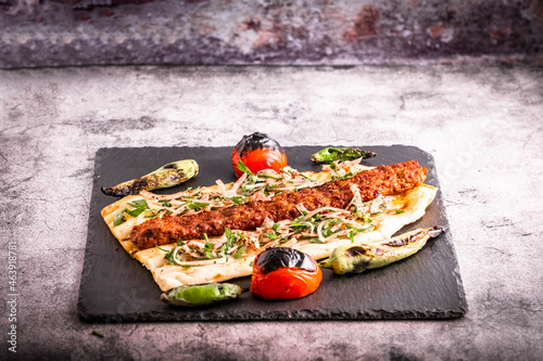 Turkish style Adana Kebab. Traditional Turkish Food Adana Kebab on presentation stone.