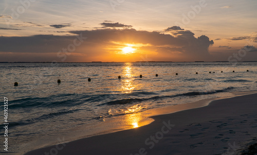 Beautiful sunset on the beach, ocean and clouds nice colours in Isla Mujeres, Mexico