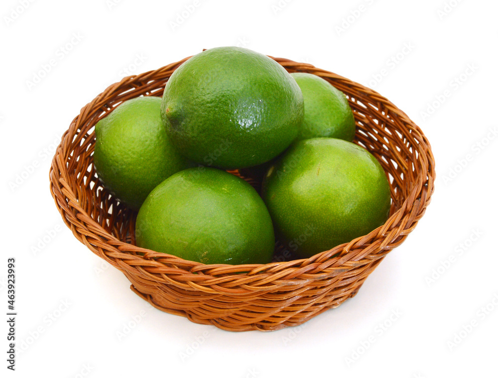 Fresh lime green in basket on a white background. Fresh lime green in basket on a white background.