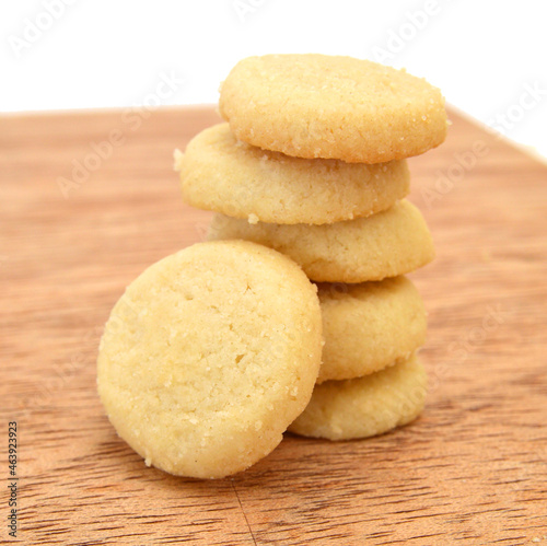 Freshly baked sugar cookies on wooden board