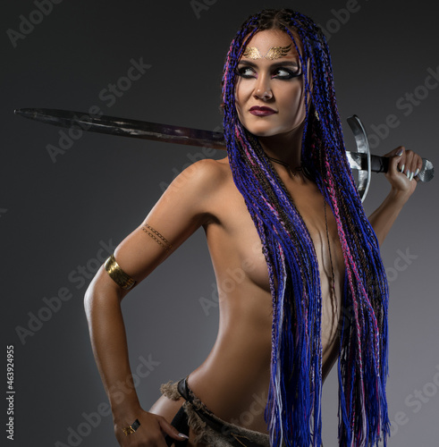 Sexy confident woman with sword in studio