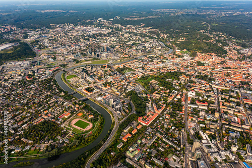 Scenic view on central part of Vilnius capital of Lithuania from hot air balloon. Neris river flowing curve through the city. Downtown district view from the sky