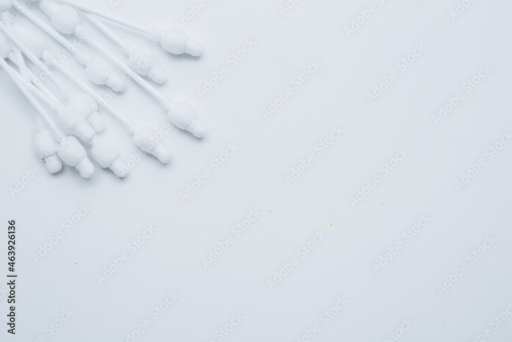 Disposable ear sticks for children are lying on a white background in the upper corner. top view, flat lay, copy space, isolate. High quality photo Disposable ear sticks for children are lying on a white background in the upper corner. top view, flat lay, copy space, isolate. High quality photo