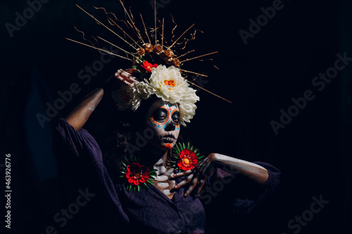 Fototapeta Naklejka Na Ścianę i Meble -  Woman with mexican halloween makeup on her face. Sugar skull day of the dead aka dia de las muertas