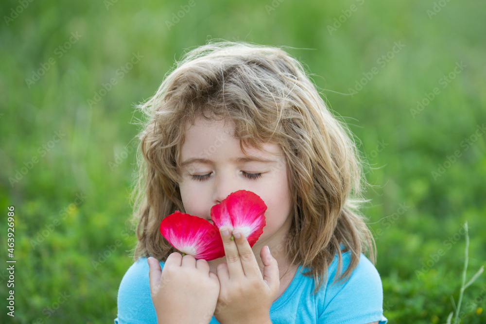 Close up head shot of child smelling flowers in spring nature park. Kids face, little boy portrait. Spring mood, enjoys pleasant smell. Close up head shot of child smelling flowers in spring nature park. Kids face, little boy portrait. Spring mood, enjoys pleasant smell.