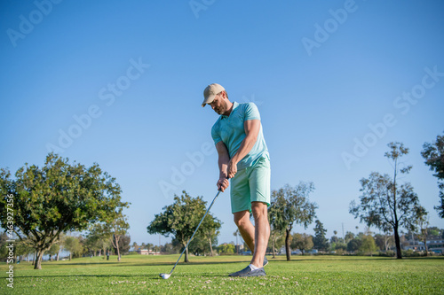 full length man playing golf game on green grass, sport