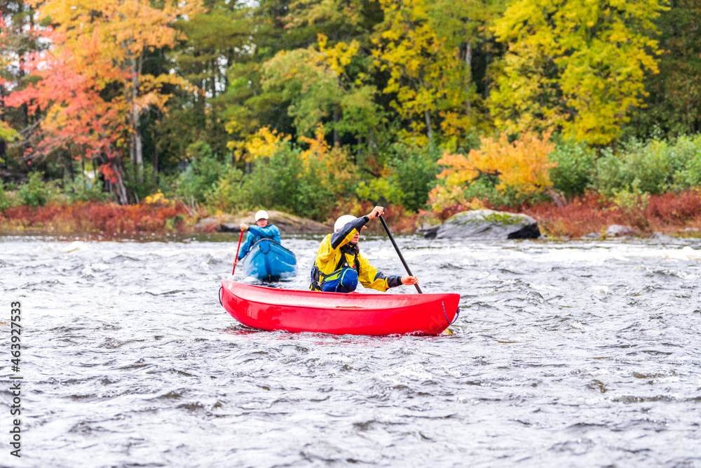A solo canoeist practices strokes on a rainy fall day during a “moving water” paddling course. Shot at Palmer Rapids on the Madawaska River an iconic paddling destination in Eastern Ontario, Canada A solo canoeist practices strokes on a rainy fall day during a “moving water” paddling course. Shot at Palmer Rapids on the Madawaska River an iconic paddling destination in Eastern Ontario, Canada