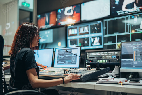 Young beautiful woman working in a broadcast control room on a tv station