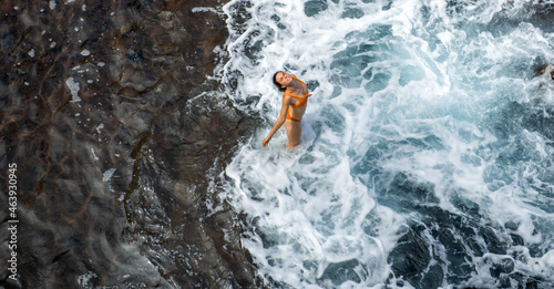 Woman in sea near the waves. Top view  aerial Shooting.
