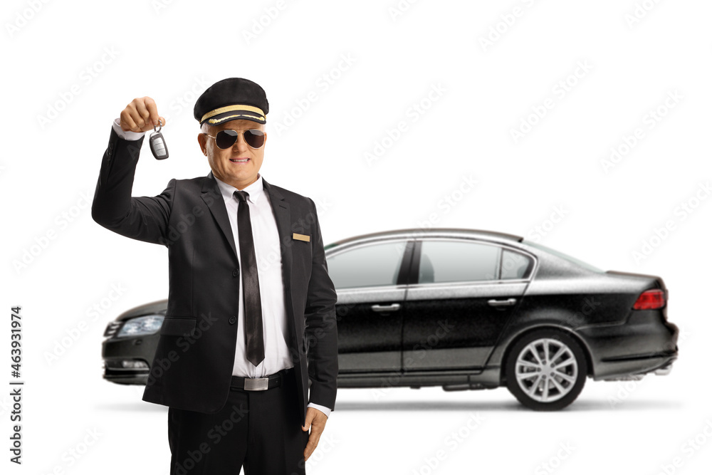 Mature chauffeur in a uniform with sunglasses holding a car key from a black car Mature chauffeur in a uniform with sunglasses holding a car key from a black car