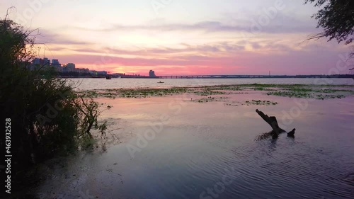 The dark silhouettes on twilight Dnieper River, Dnipro, Ukraine photo