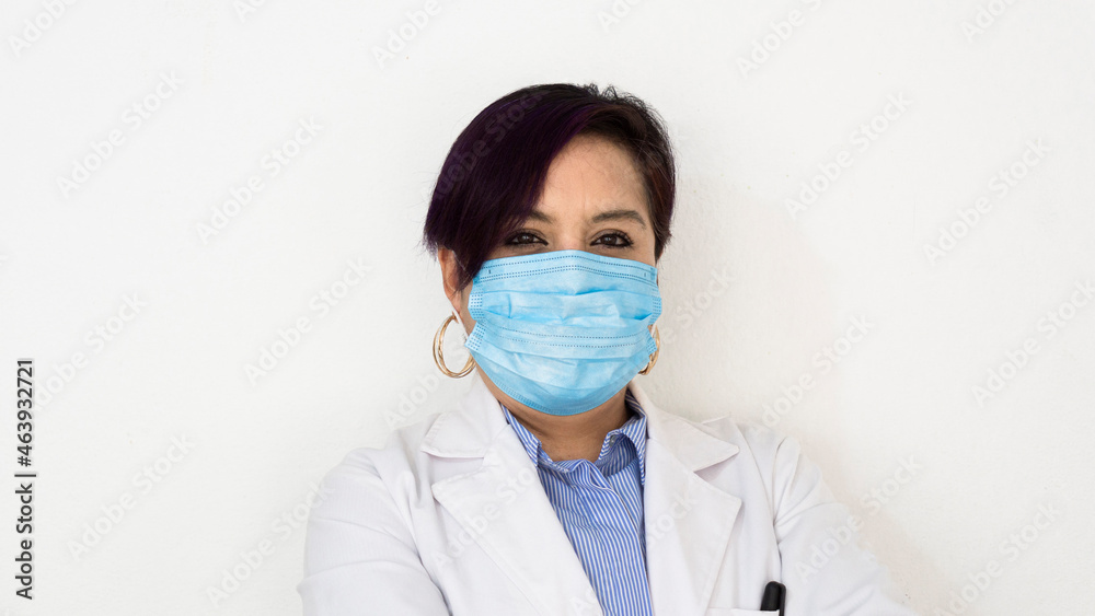 Doctor wearing a mask looking at the camera, on white background Doctor wearing a mask looking at the camera, on white background