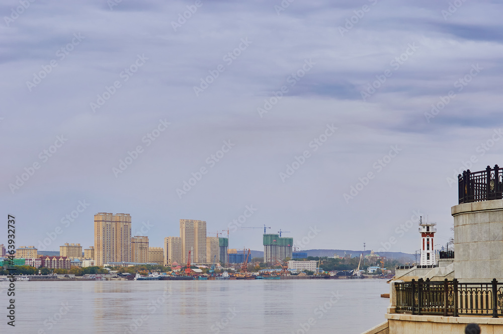 Amur river. Lighthouse on the embankment of Blagoveshchensk, Russia. Heihe city, China across the river.