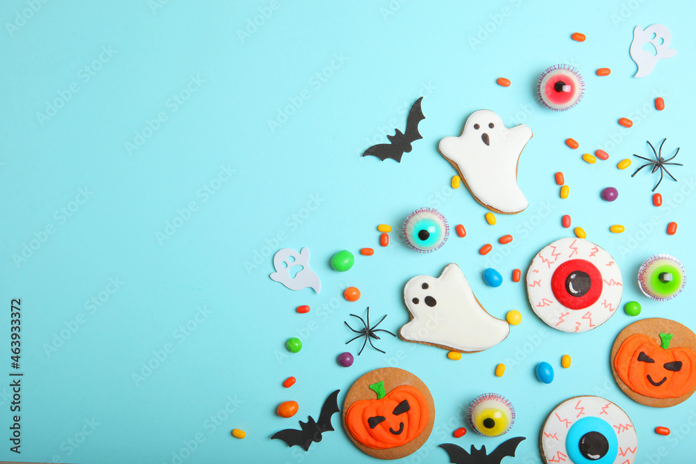 Halloween sweets on colored background close up top view with place for text