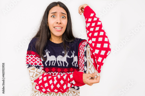 christmas gift become a bad santa idea on a unhappy woman, ugly sweater for christmas celebration © Sangiao_Photography
