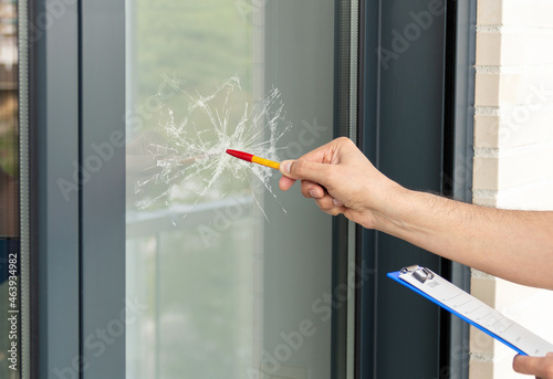 Close-up of a man's hand checking to repair glass in a house for a window accident