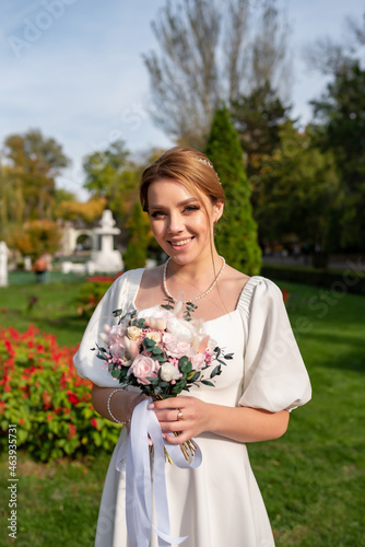 Bride in a white dress after the wedding ceremony on a walk in the autumn park
