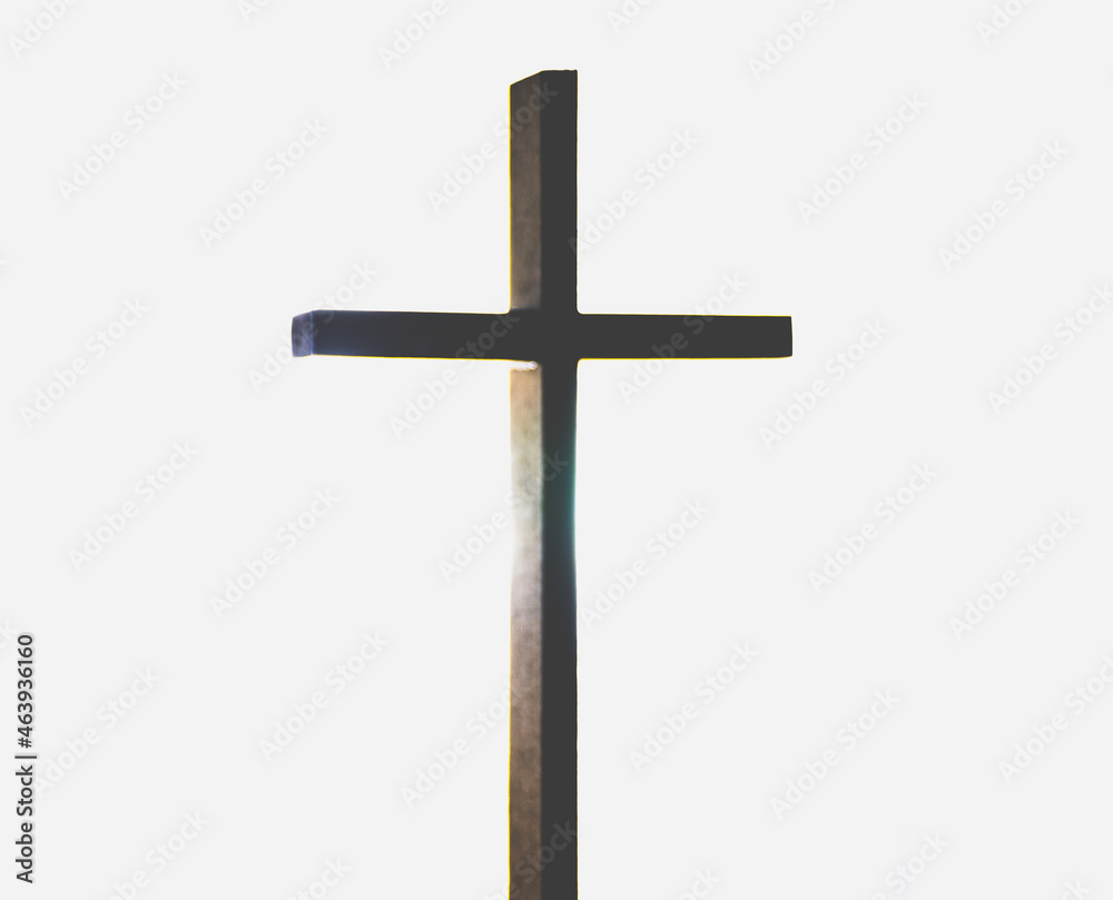 wooden Christian cross or crucifix with back lighting and a white background with light glistening off center
