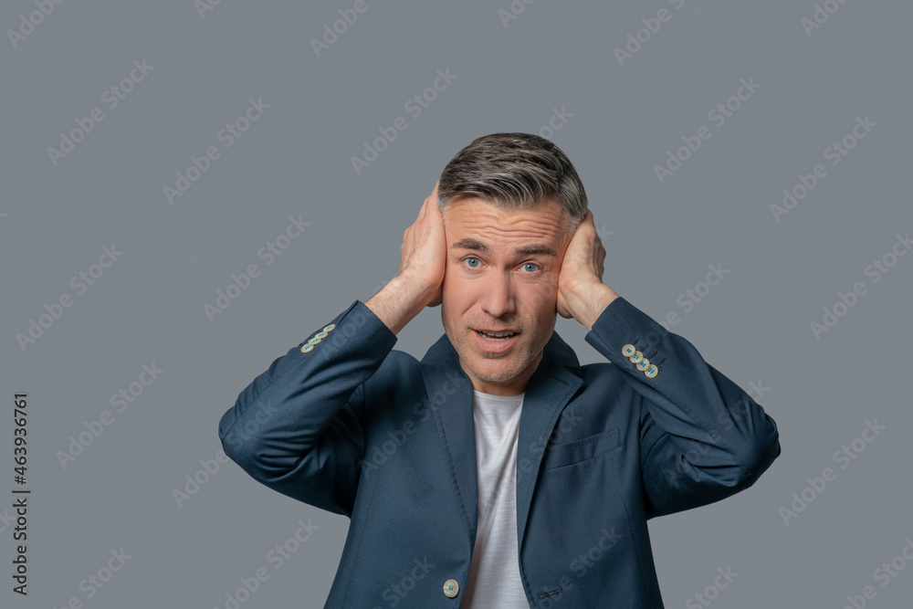Unhappy man touching head with his hands Unhappy man touching head with his hands