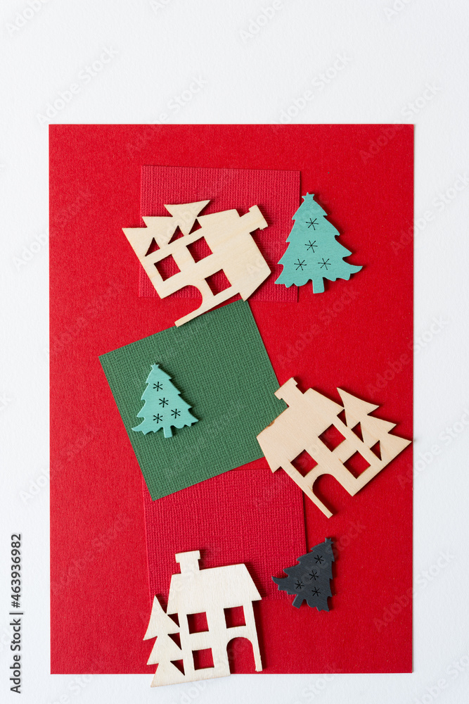 wooden christmas village and tree shapes or silhouettes arranged on paper