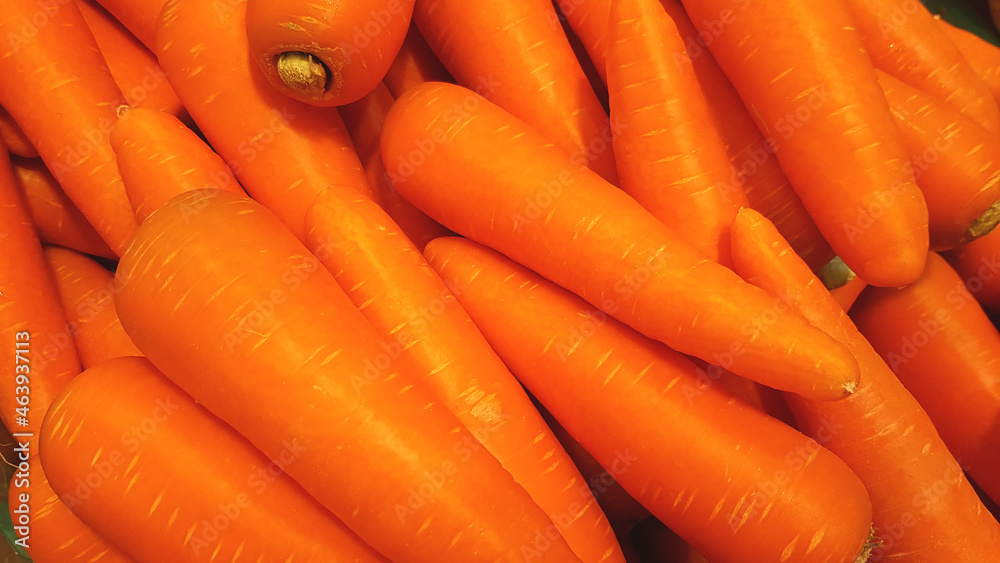 Many carrots are placed together in the shop for sale. Many carrots are placed together in the shop for sale.
