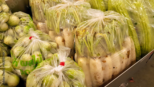 Tableau sur toile Vegetables are in plastic bags in shelves for sale.