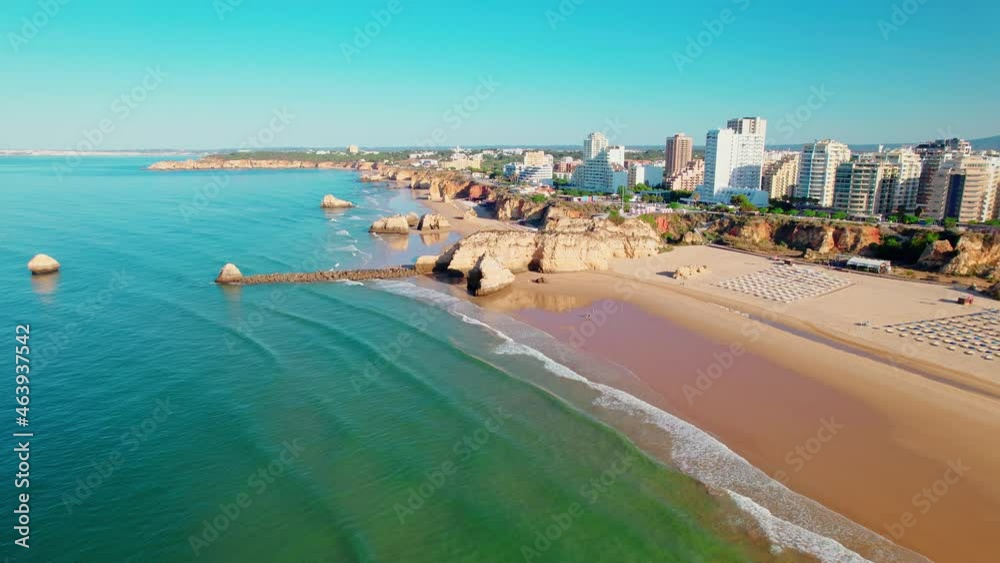 Drone 4K aerial view of Praia da Rocha Beach in Portimão, Algarve, Portugal. Famous luxury holiday hotels and expensive residential areas in Portugal, a coastline with turquoise water and a huge beach Drone 4K aerial view of Praia da Rocha Beach in Portimão, Algarve, Portugal. Famous luxury holiday hotels and expensive residential areas in Portugal, a coastline with turquoise water and a huge beach