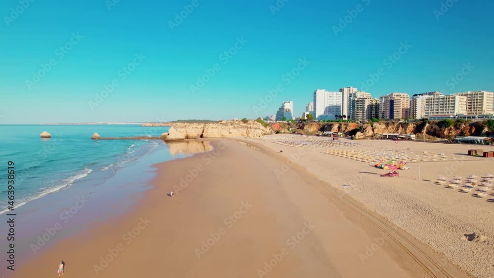 Drone 4K aerial view of Praia da Rocha Beach in Portimão, Algarve, Portugal. Famous luxury holiday hotels and expensive residential areas in Portugal, a coastline with turquoise water and a huge beach Drone 4K aerial view of Praia da Rocha Beach in Portimão, Algarve, Portugal. Famous luxury holiday hotels and expensive residential areas in Portugal, a coastline with turquoise water and a huge beach