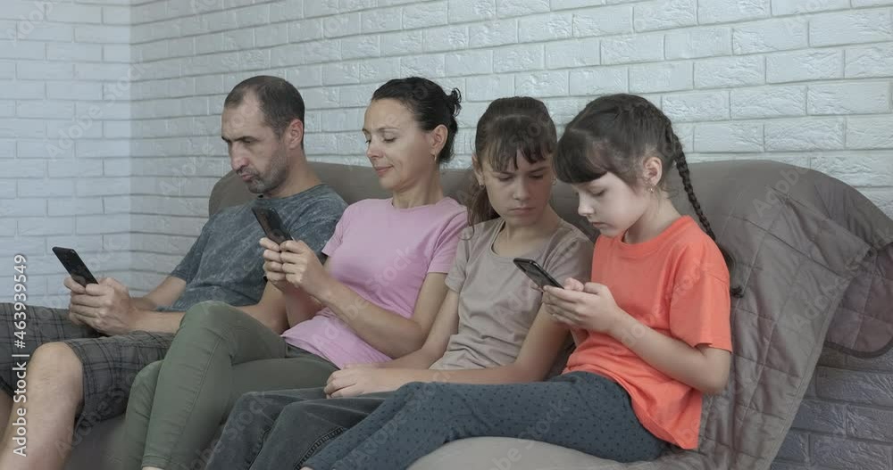 Devices addiction by child. Parents and sister ingore little girl and browsing in internet all free time. Devices addiction by child. Parents and sister ingore little girl and browsing in internet all free time.