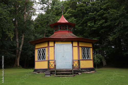 Small yellow cottage at the Slotspark Park in Denmark photo