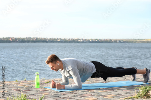 Sporty young man doing plan...