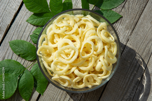 Onion rings. Onion chips top view. Chips in a glass bowl.