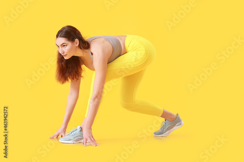 Sporty female runner on col...