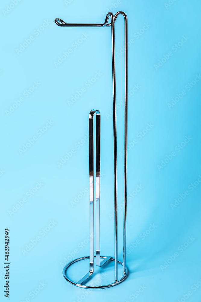 Empty toilet paper holder on blue background Empty toilet paper holder on blue background