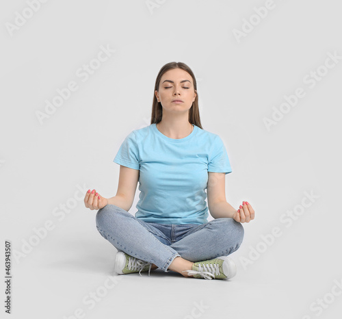 Young woman meditating on l...