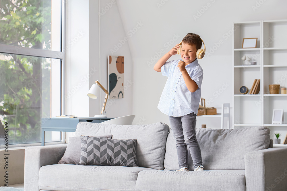 Cute little boy in headphones singing at home Cute little boy in headphones singing at home