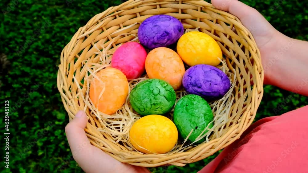 Easter Egg Hunt. Easter eggs set in a basket in children's hands on green grass background.Colorful easter eggs. Collecting Easter eggs. Religious holiday tradition. 4k footage Easter Egg Hunt. Easter eggs set in a basket in children's hands on green grass background.Colorful easter eggs. Collecting Easter eggs. Religious holiday tradition. 4k footage