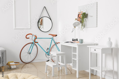 Comfortable living room interior with modern bicycle © Pixel-Shot
