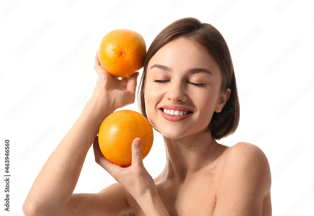 Naked young woman with grapefruits on white background. Vegan Day Naked young woman with grapefruits on white background. Vegan Day