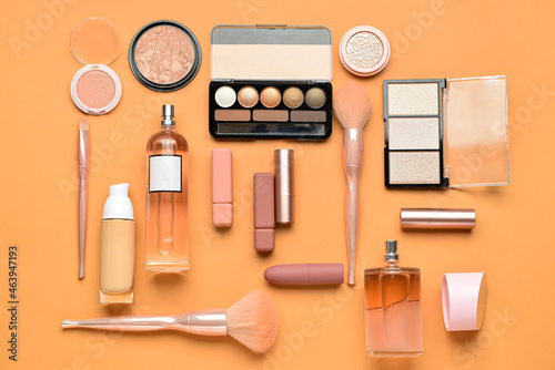 Set of decorative cosmetics and perfume bottle on color background