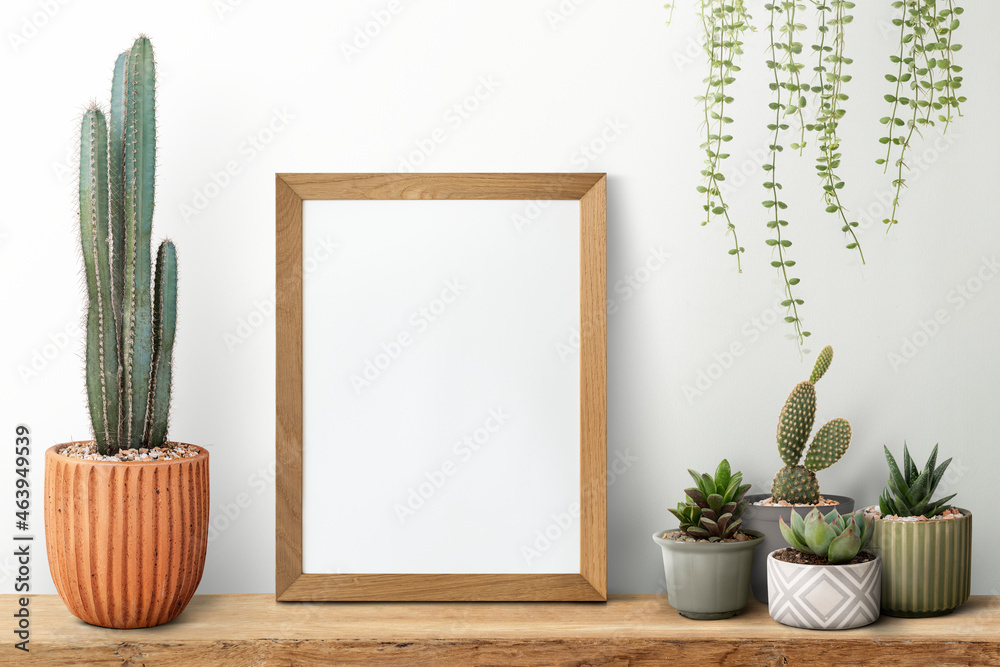 Wooden picture frame on a shelf with cactus - obrazy, fototapety, plakaty 