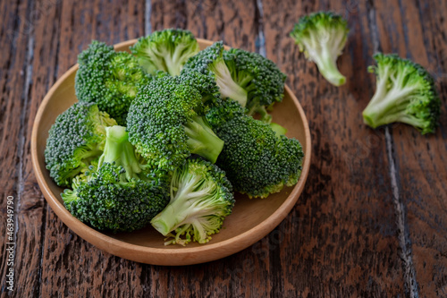 Fresh green broccoli on wooden plate