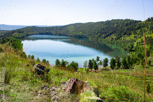 Lake in the crater of an ancient volcano. The color changes in the place of a tectonic fault. Lake Krugloye, Kuznetsk Alatau Mountain Range, Krasnoyarsk Territory, Siberia, Russia.