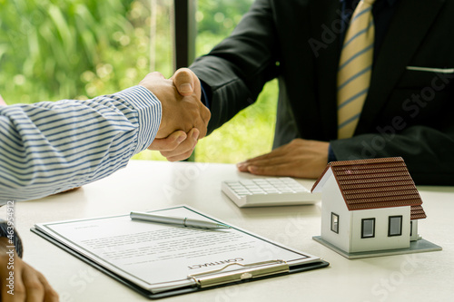Real estate agents and clients shake hands after contracts involving home insurance and investment loans. Handshake and a successful deal Ideas for buying and selling a house