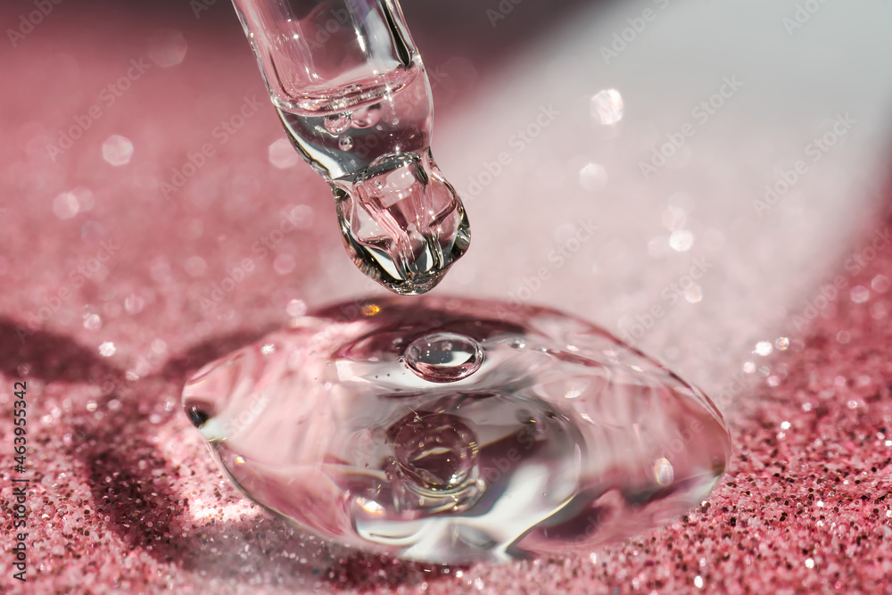 Cosmetic pipette with a pink on dark background. Cosmetic pipette with a pink on dark background.