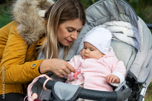 Happy beautiful mother spending time with her little baby girl in nature.