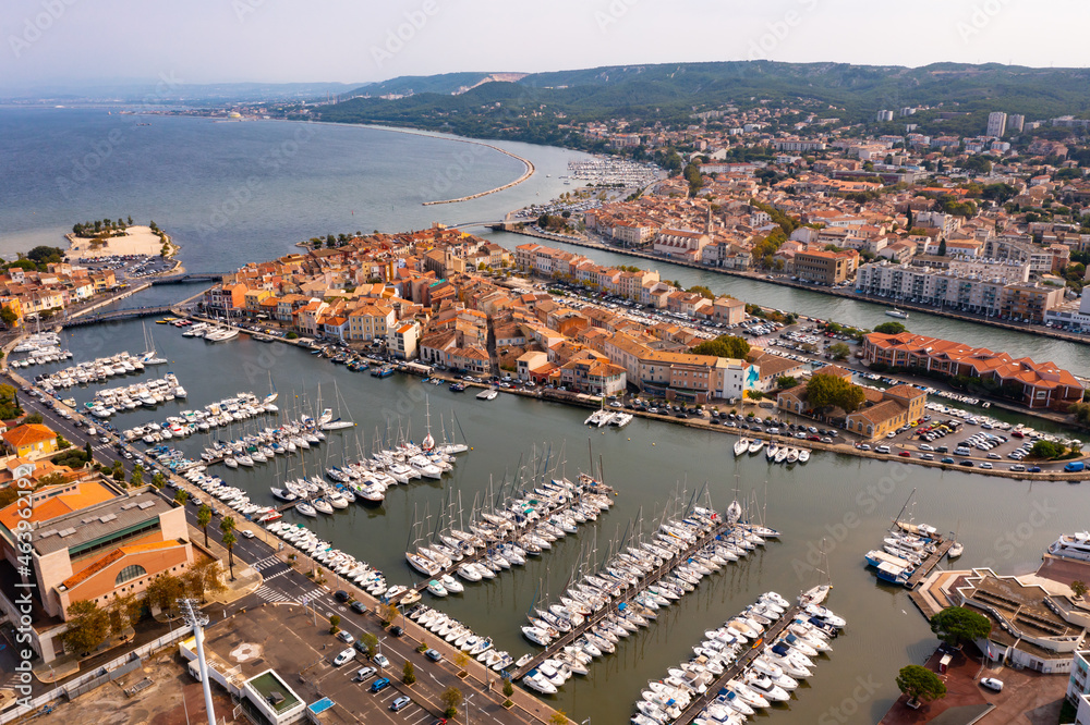 Aerial panoramic view of landscape of old town of Martigues on Mediterranean coast with scenic canals and marina on summer day, Bouches-du-Rhone department, France..