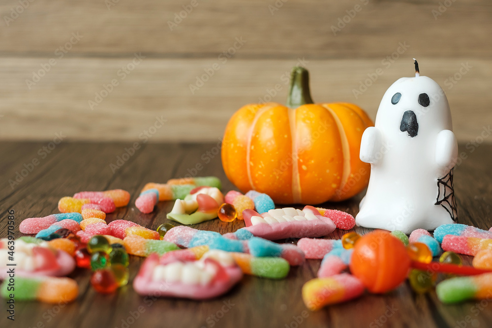 Happy Halloween day with ghost candies, candle, pumpkin, Jack O lantern and decorative (selective focus). Trick or Threat, Hello October, fall autumn, Festive, party and holiday concept