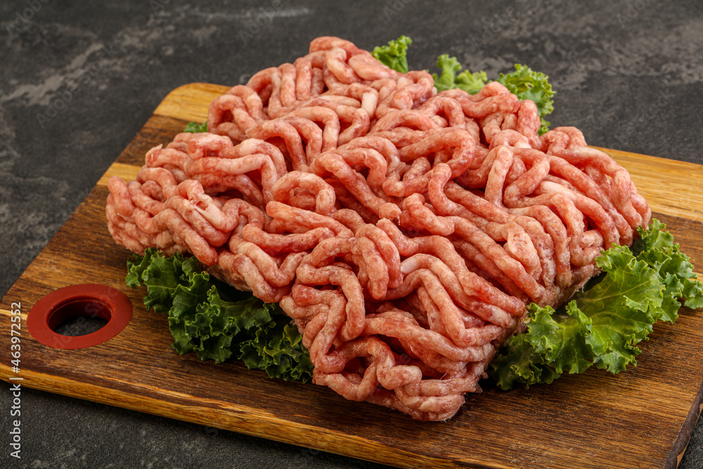 Raw pork minced meat over board Raw pork minced meat over board