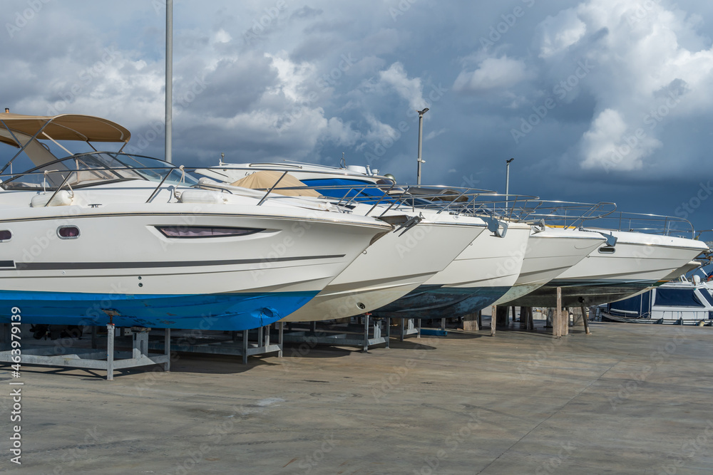 Fototapeta premium Recreational boats supported on metal tripods for future restoration. S'Estanyol marina, island of Mallorca, Spain